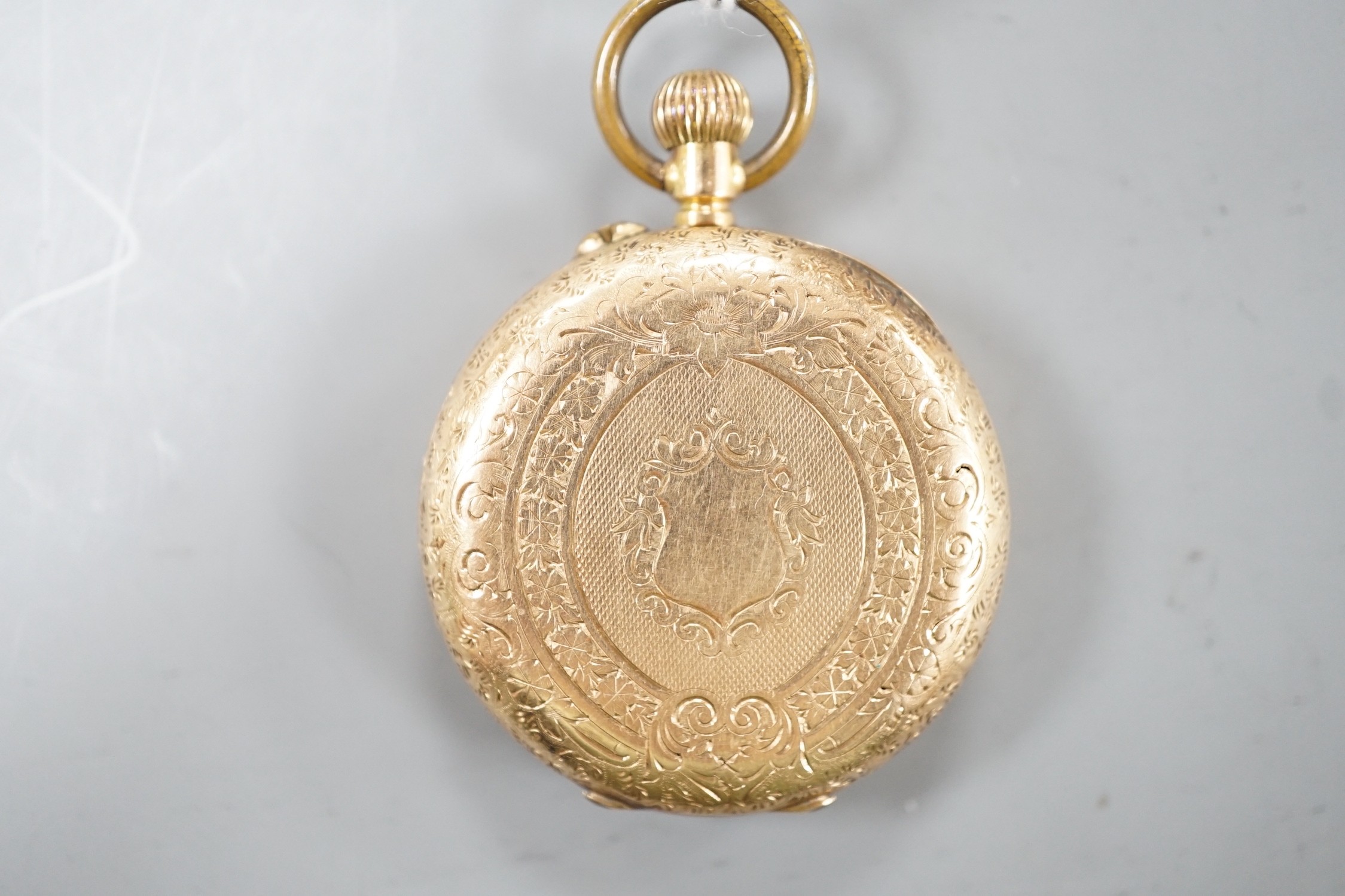 An engraved 14k open face fob watch, with Roman dial, 37m, gross weight 38.7 grams.
